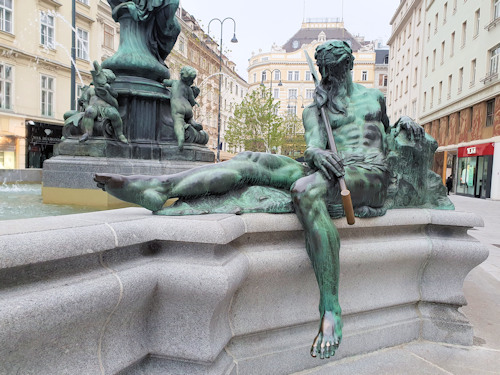 River statue at the side of a fountain