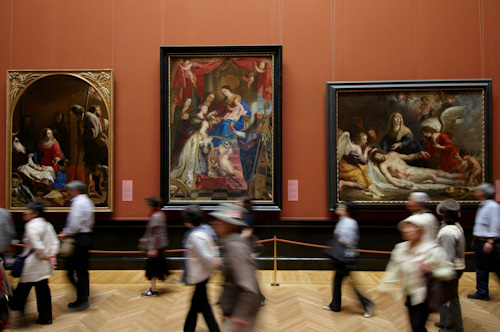 Three paintings by Old Masters in a gallery
