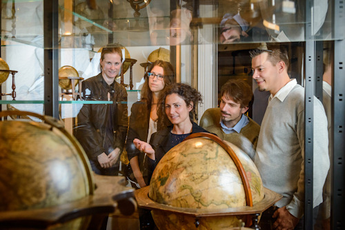 People looking at globes